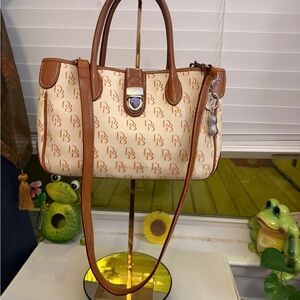 Vintage Dooney and Bourke monogram canvas shoulder purse trimmed in leather.